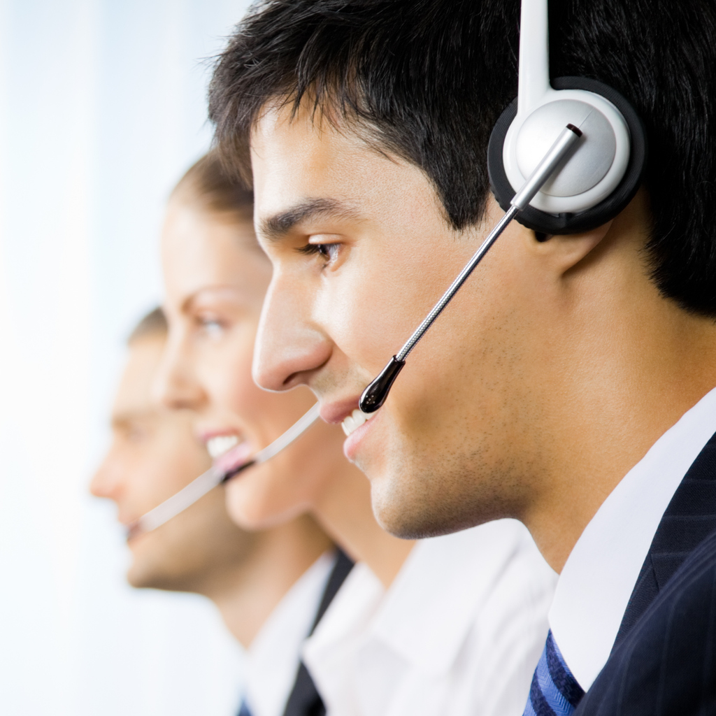 Three support phone operators at workplace